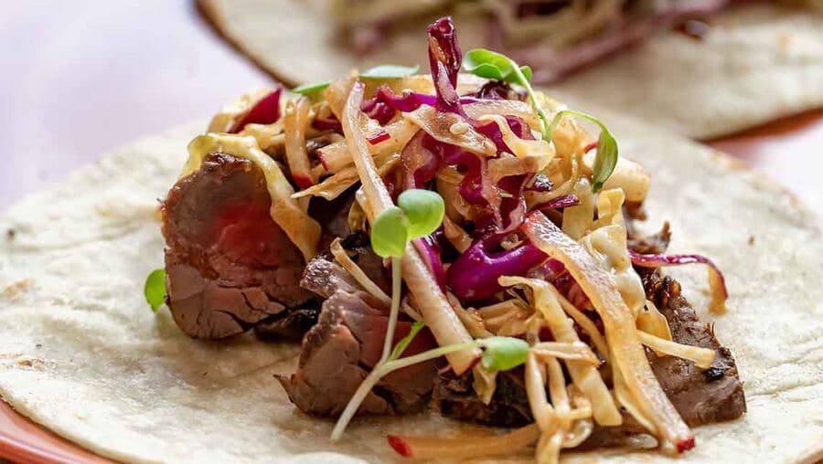 Steak tacos with fresh garnishes